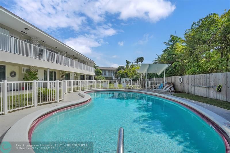 a view of a swimming pool with a patio