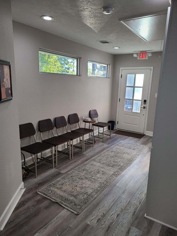 a view of a workspace with furniture and window