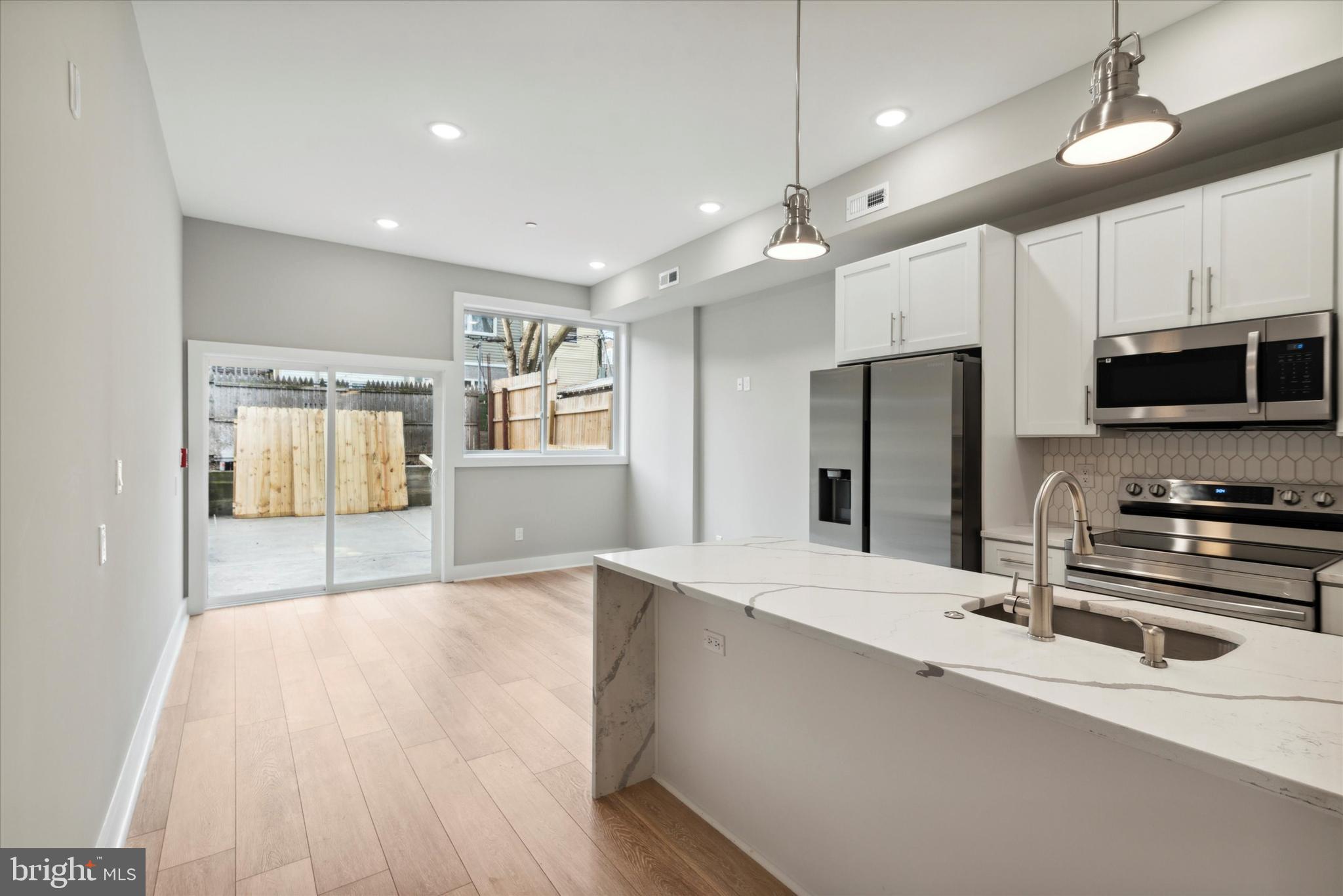 a kitchen with stainless steel appliances a refrigerator and a stove top oven