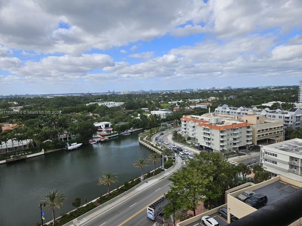 an aerial view of a city with lots of residential buildings lake and ocean view