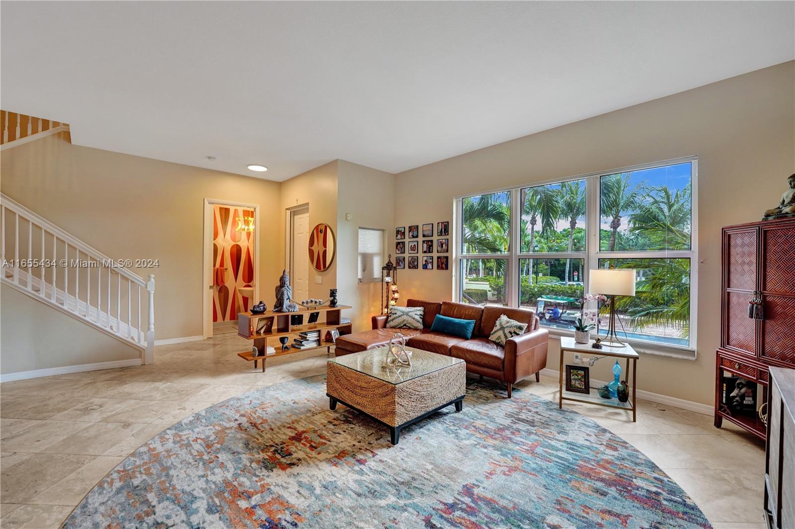 a living room with furniture and a floor to ceiling window