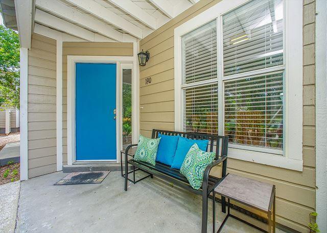 a blue bench sitting in front of a door