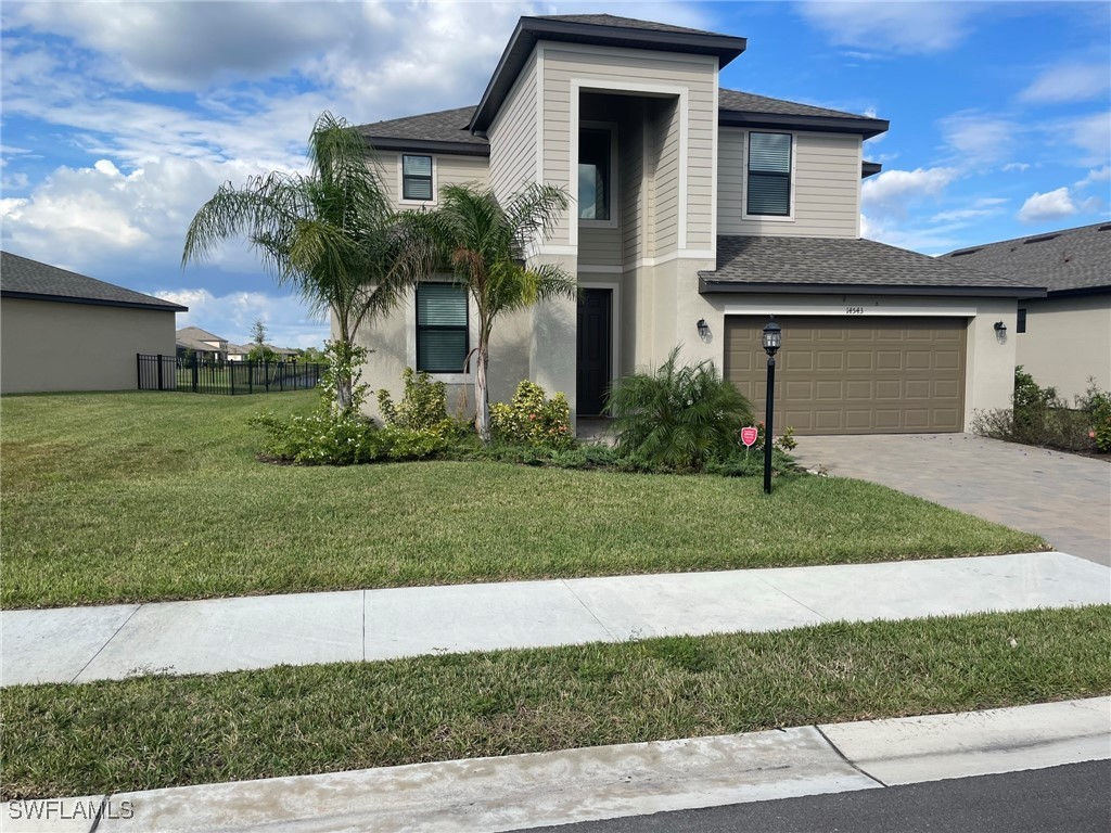 a front view of a house with a yard and garage