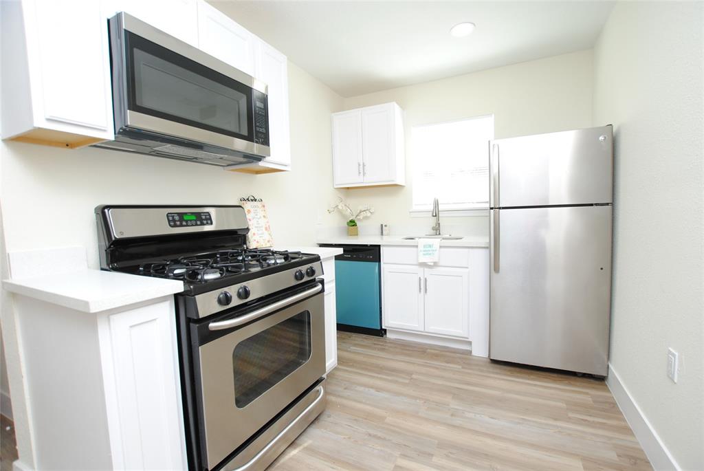 a kitchen with a stove microwave and refrigerator