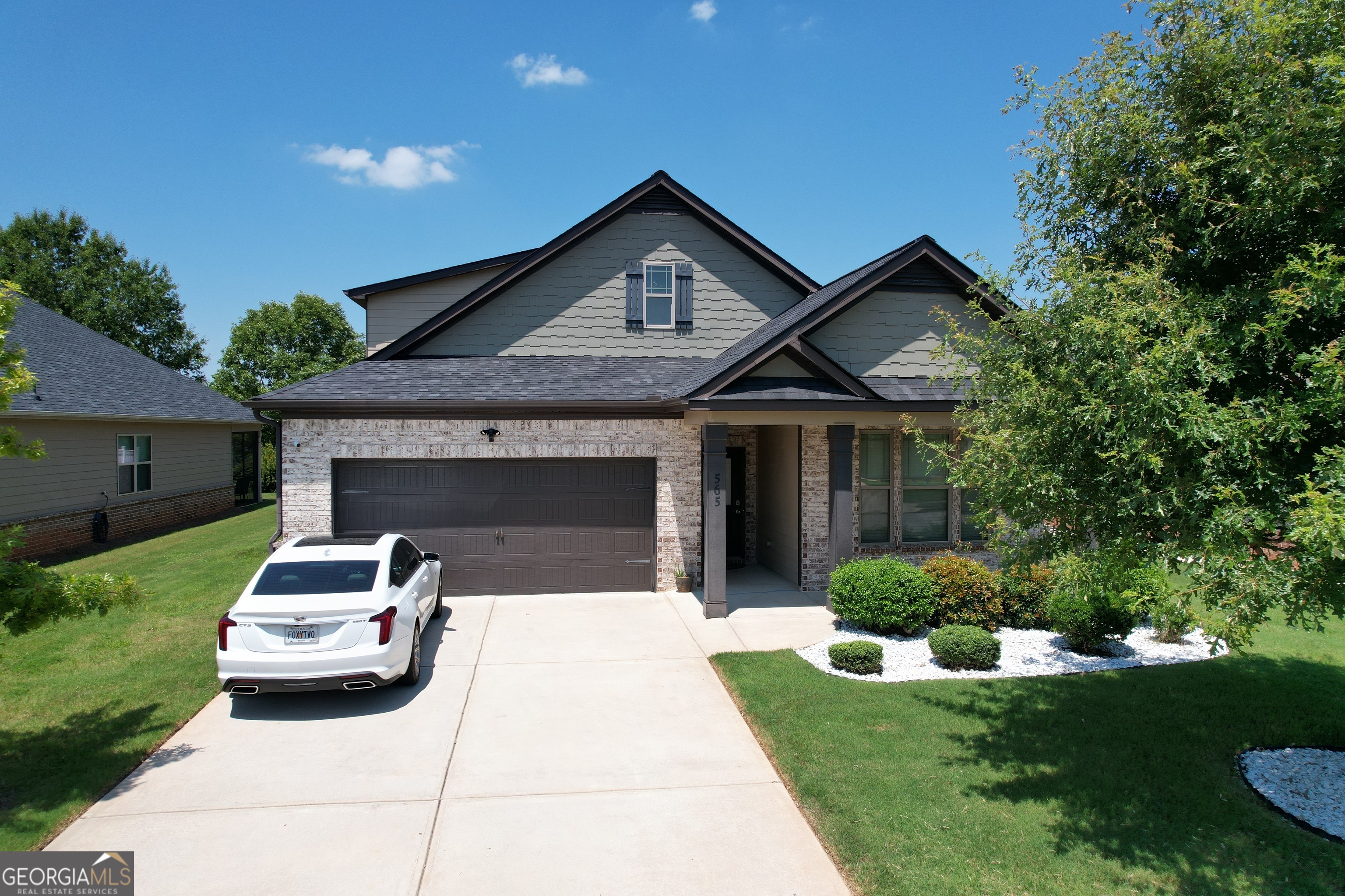 a front view of a house with a garden