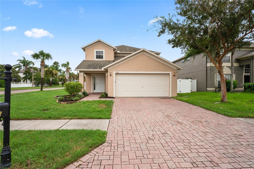 a front view of a house with a yard and garage