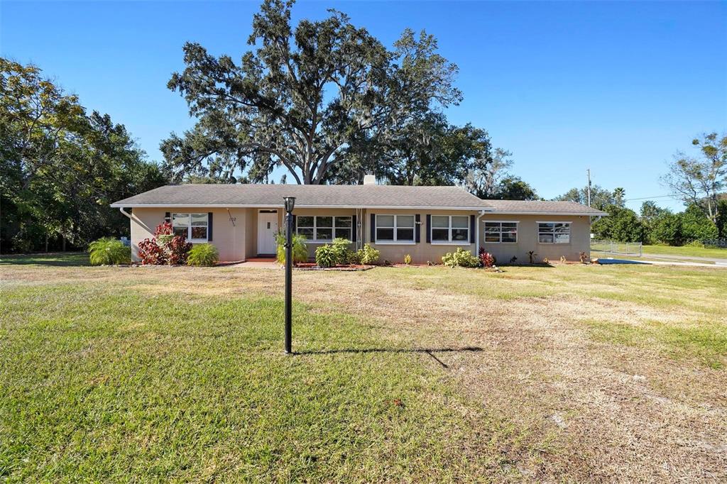 a view of house with a yard