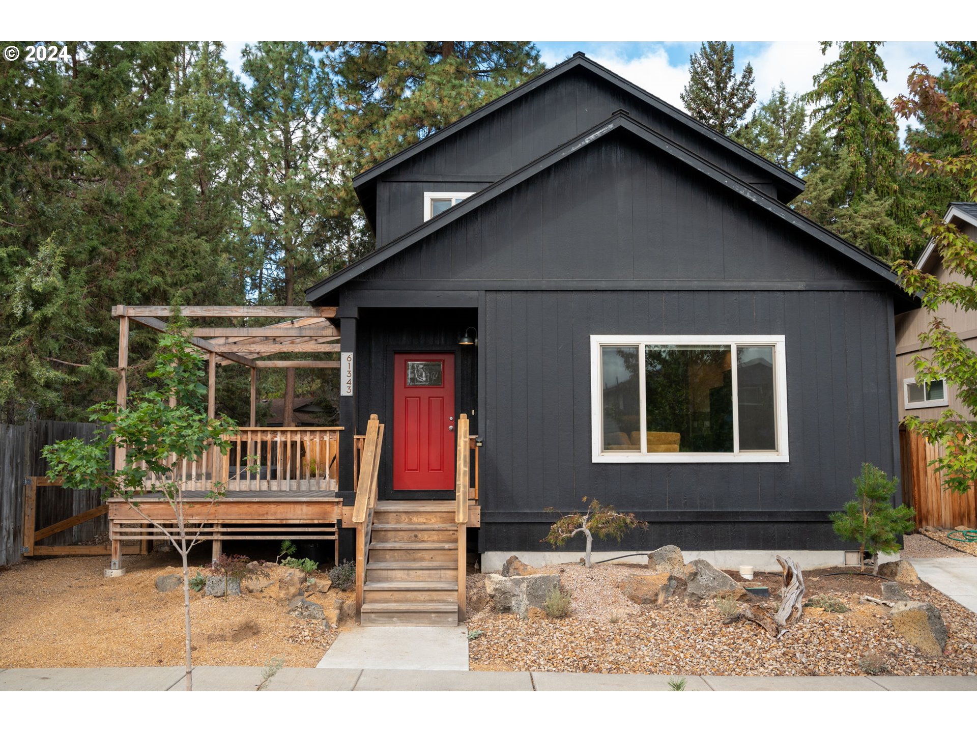 a backyard of a house with barbeque oven and outdoor seating