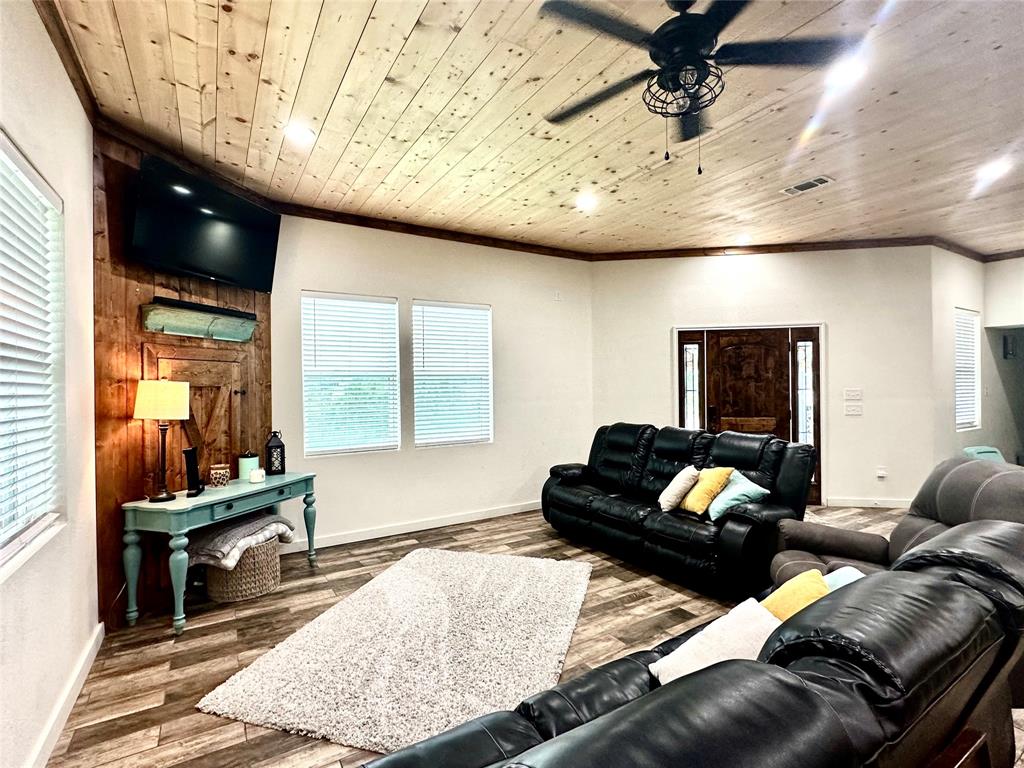 a living room with furniture and wooden floor