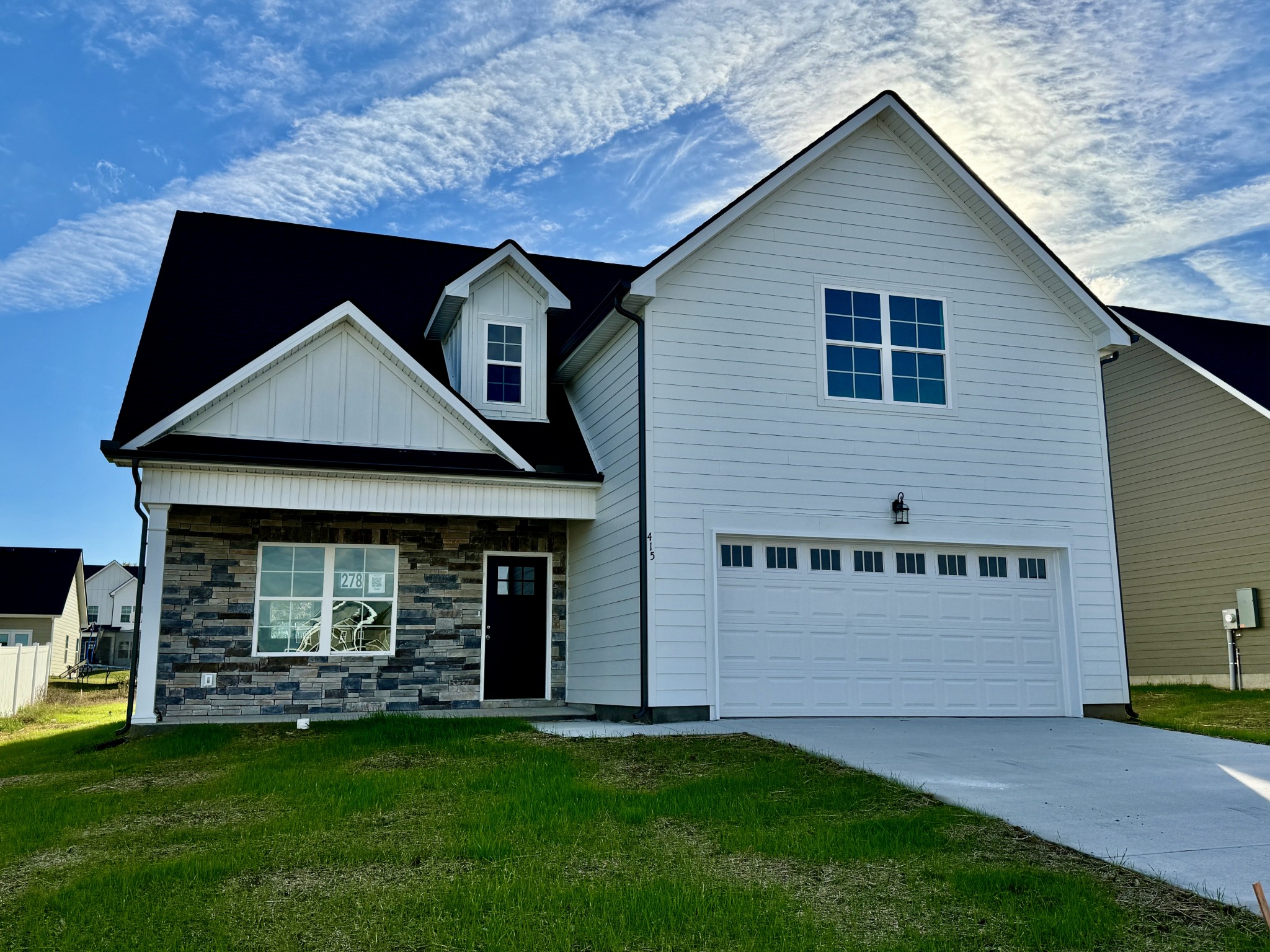 a front view of a house with a yard