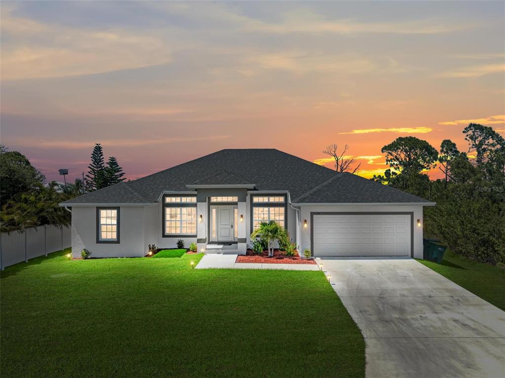 a front view of a house with a yard and garage