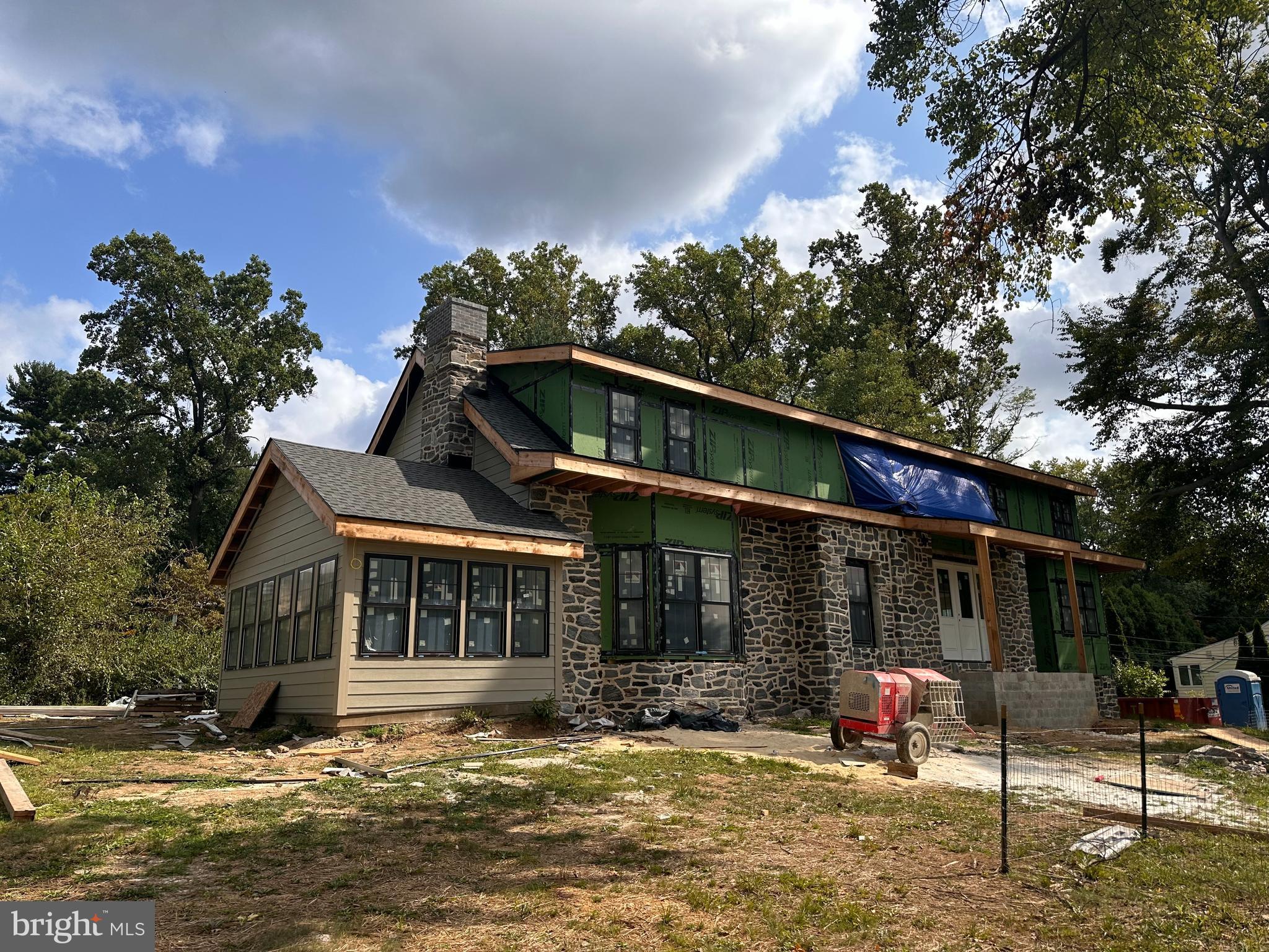 a front view of a house with swimming pool and porch