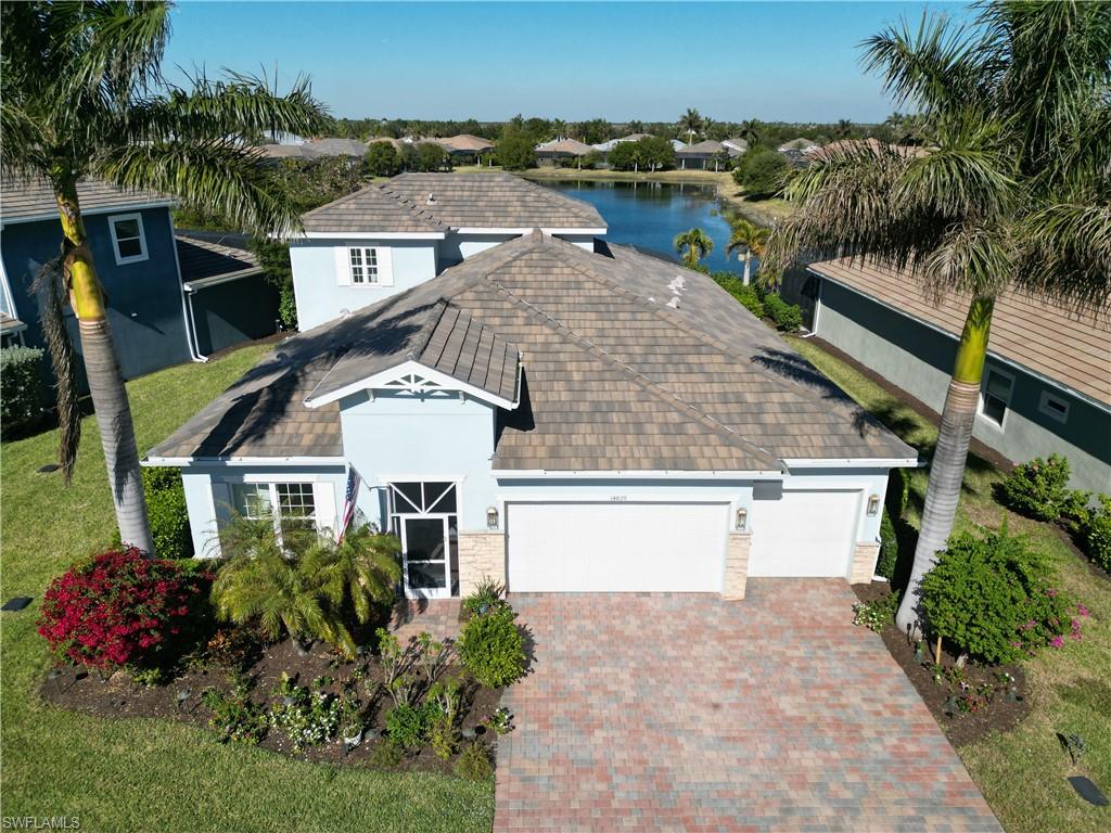 an aerial view of a house with a yard and potted plants