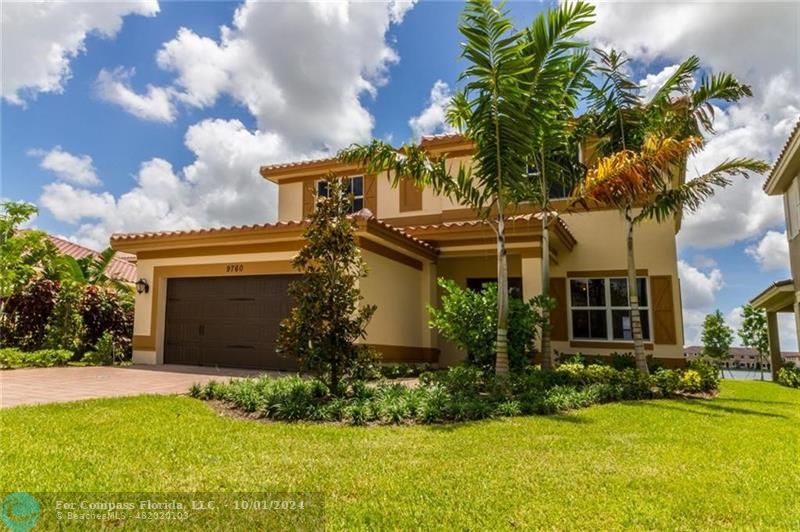 a view of a house with a yard and palm trees