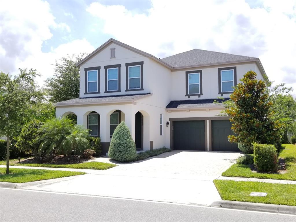 a front view of a house with a yard and garage