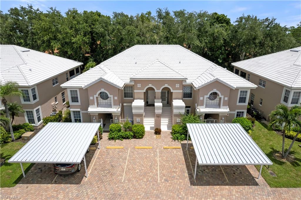 a view of a white house with a yard