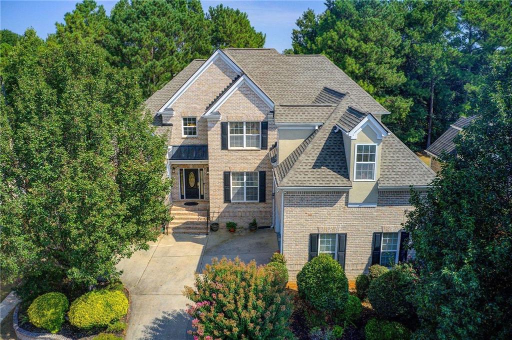 a aerial view of a house next to a yard