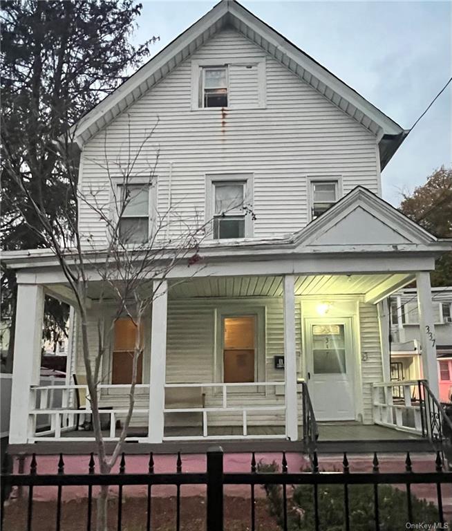 a view of a white building with large windows