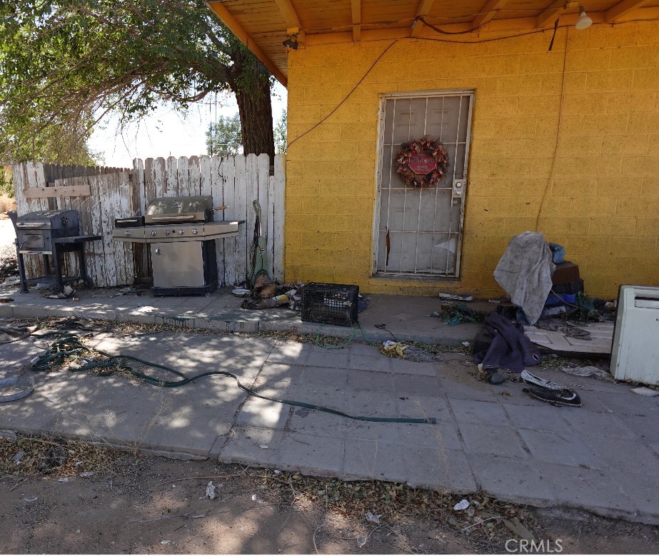 a backyard of a house with table and chairs