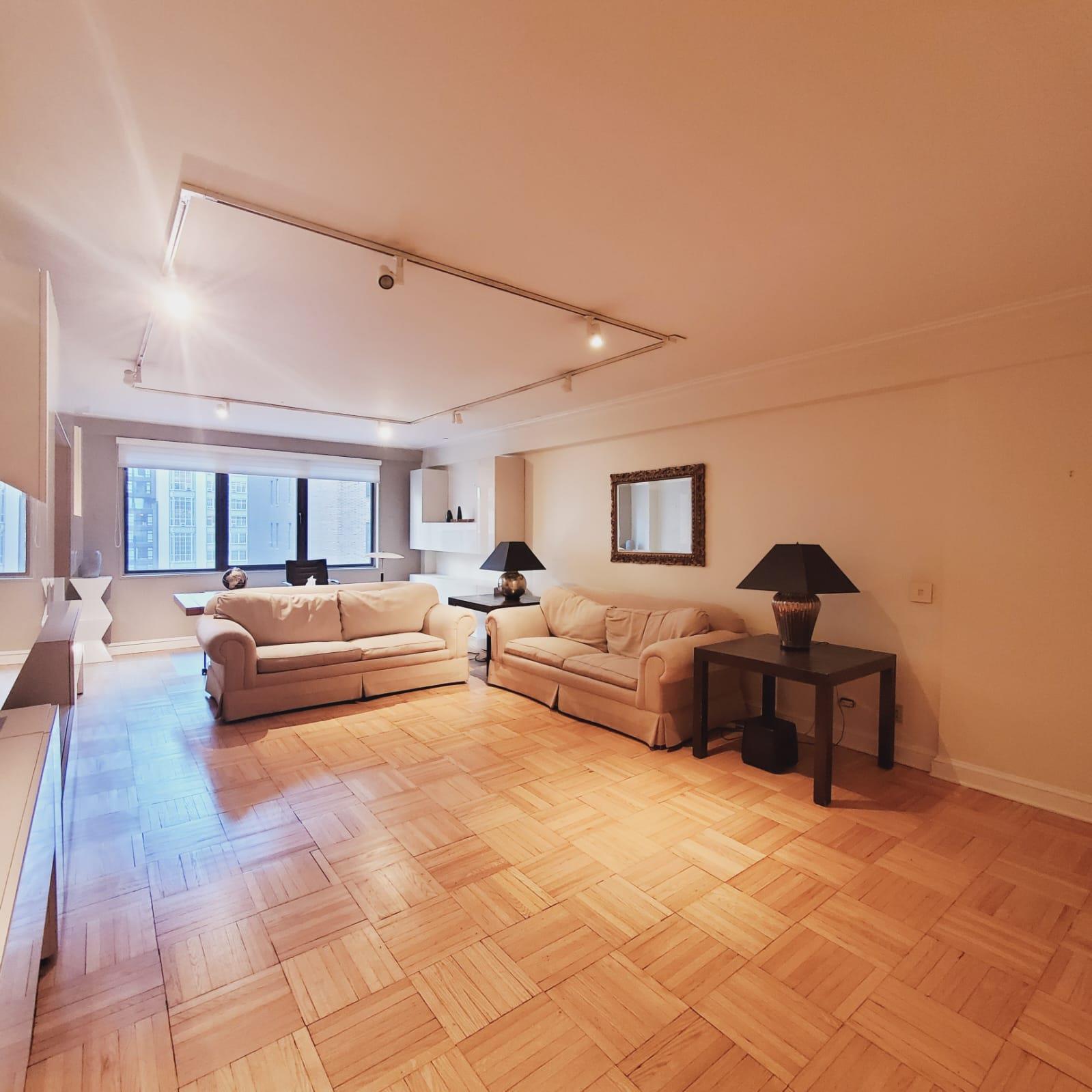 a living room with furniture and a rug