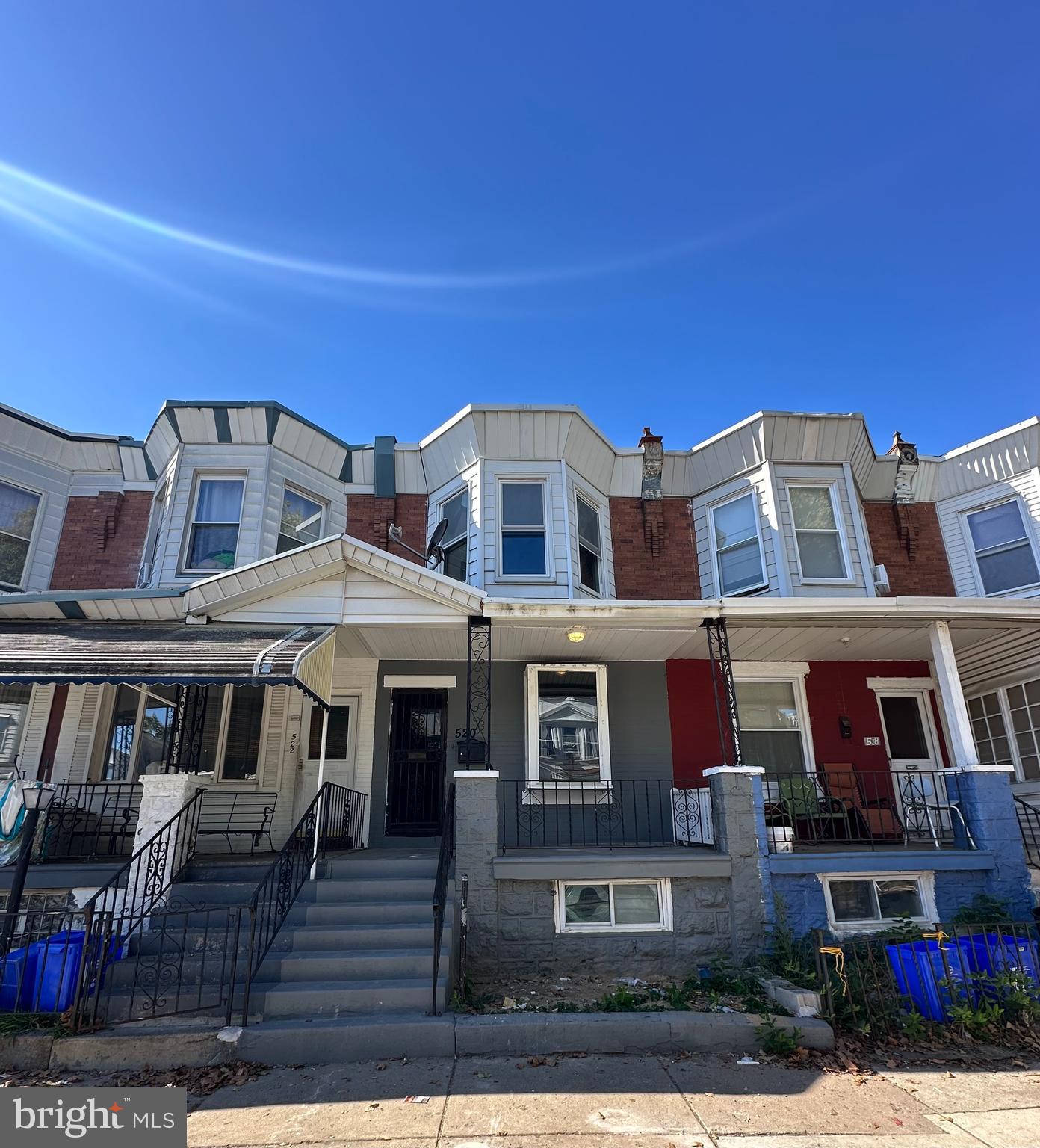 a front view of a residential apartment building with a yard