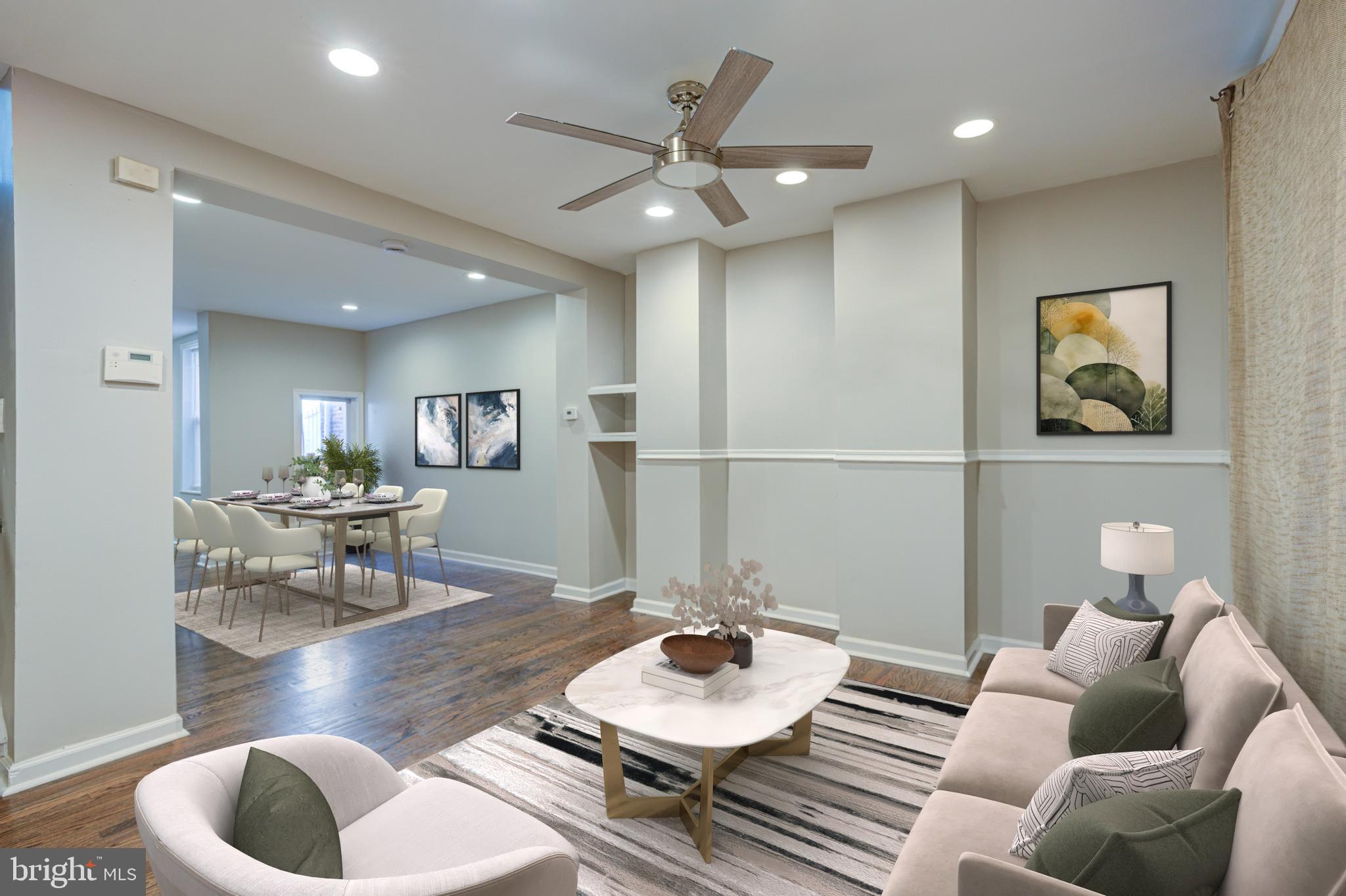 a living room with furniture and a wooden floor