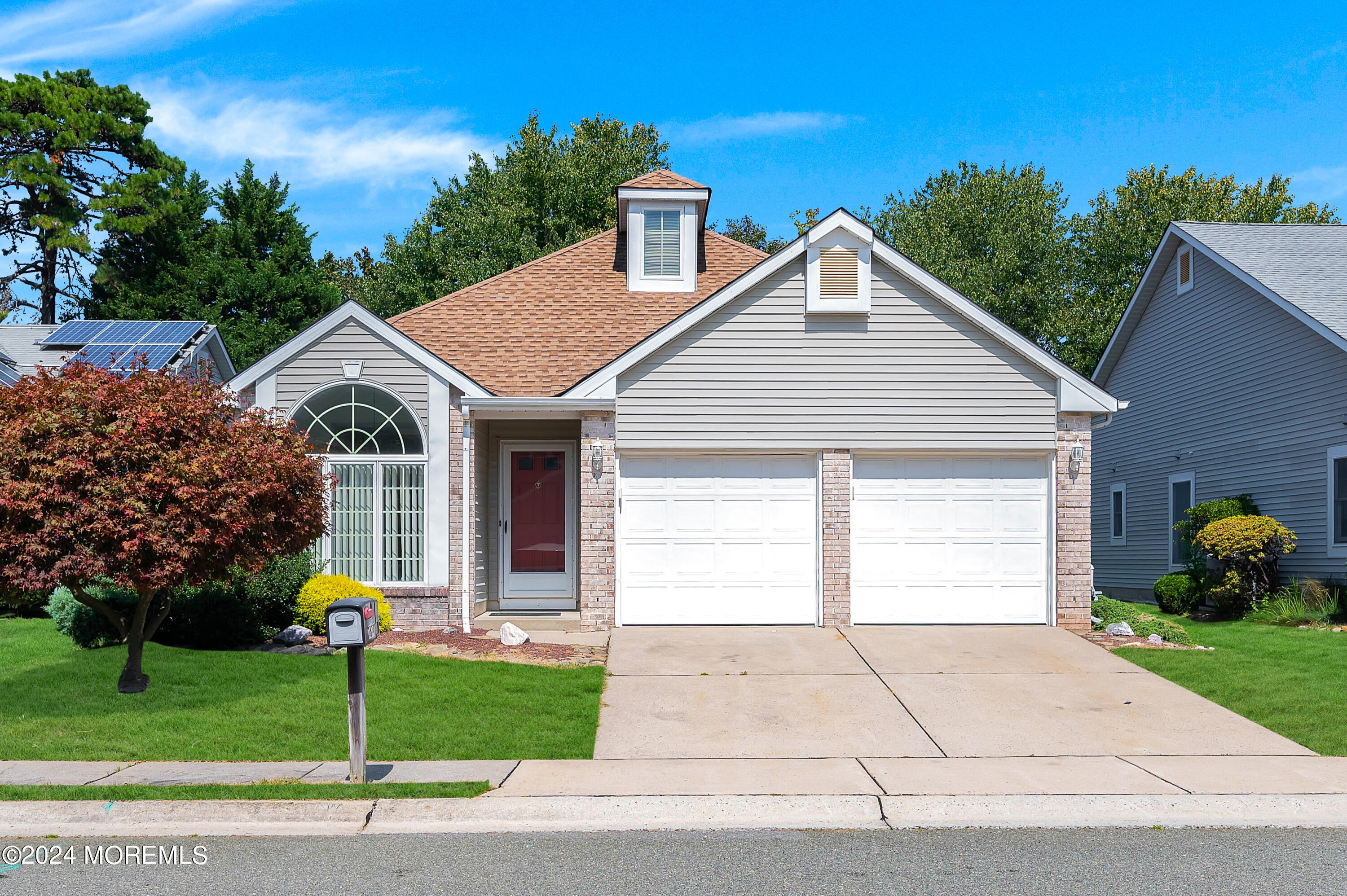 a front view of house with garage and green space