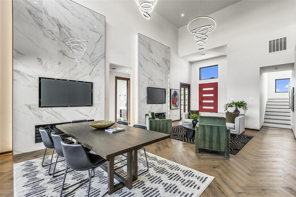 a living room with furniture a flat screen tv and kitchen view