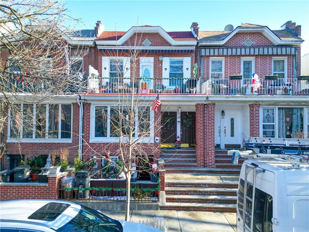 a front view of a residential apartment building with a yard