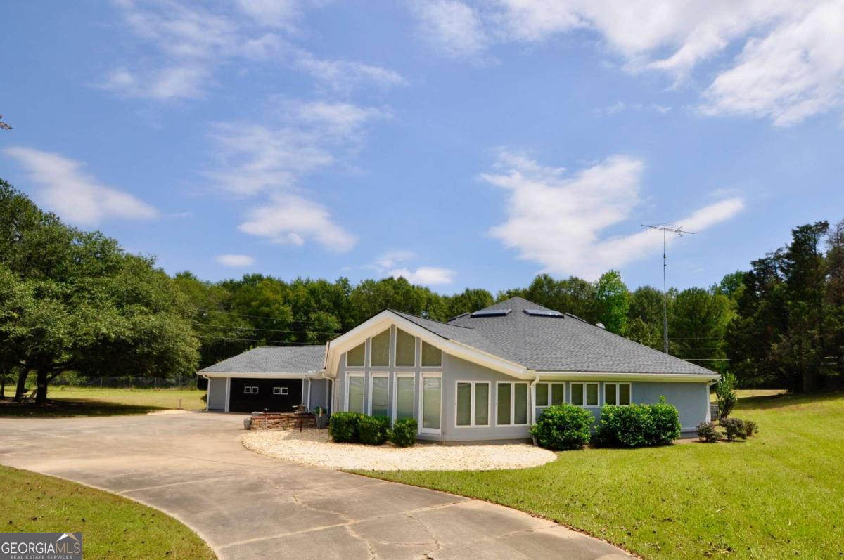 a view of house with yard and green space