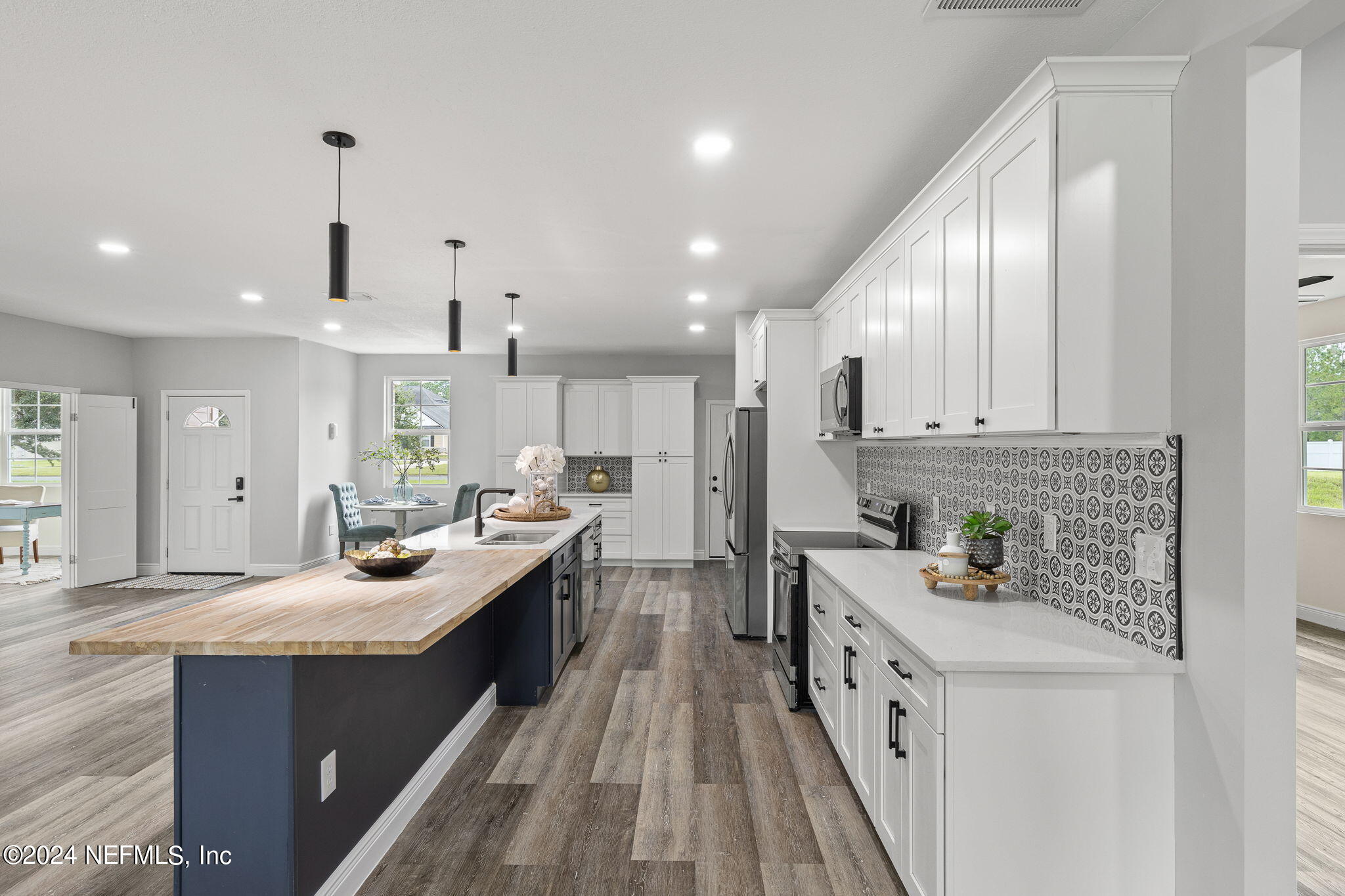 a kitchen with stainless steel appliances granite countertop a sink stove and cabinets