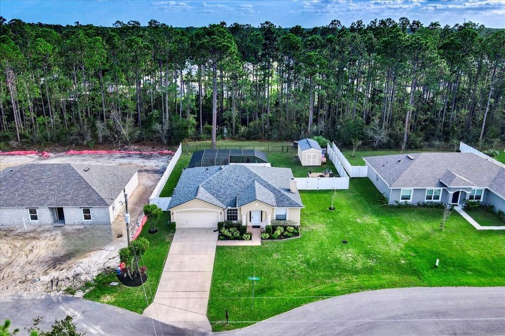 a aerial view of a house with pool