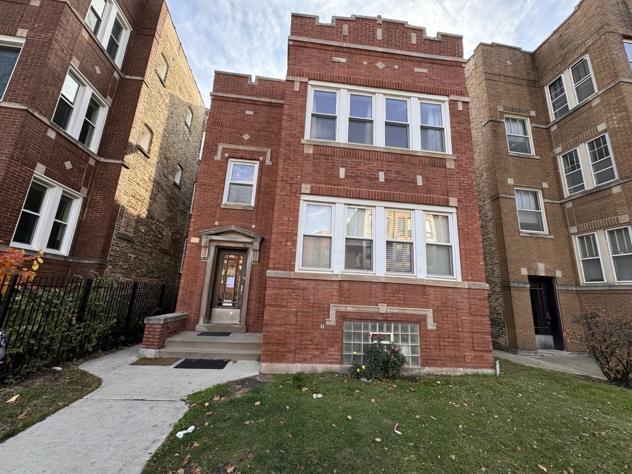 a view of a brick building next to a yard