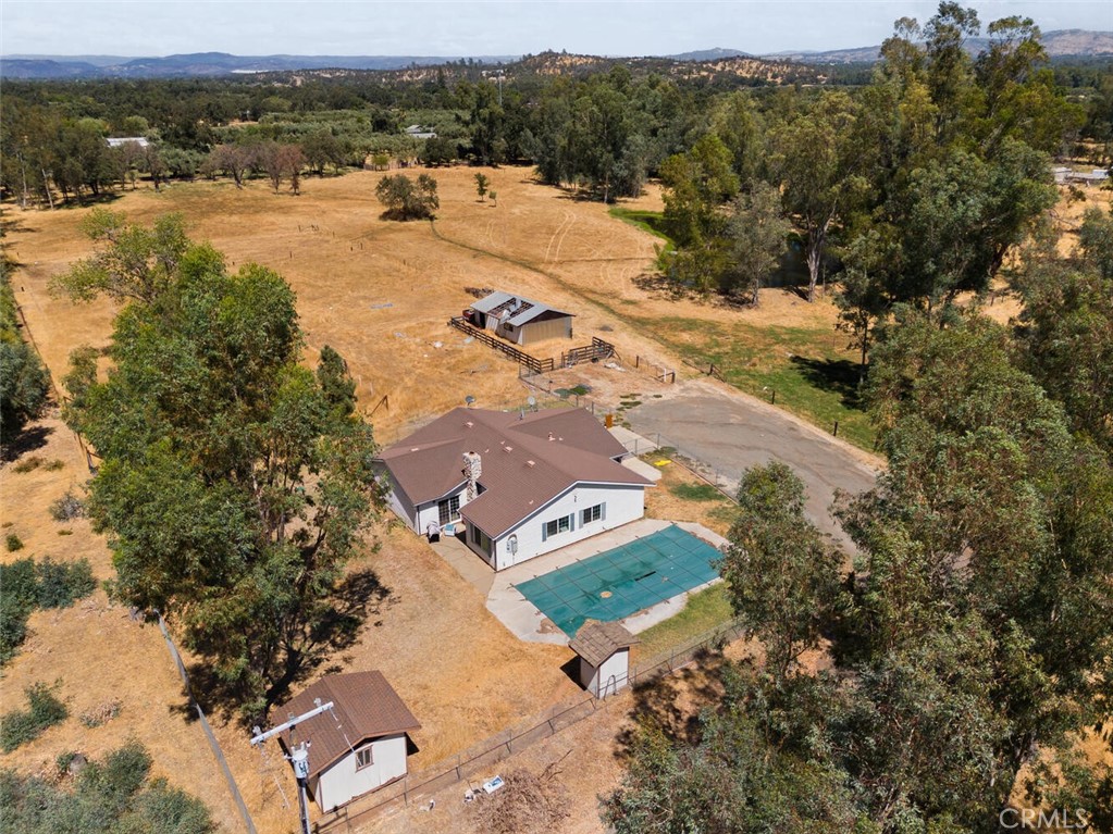 an aerial view of a house with yard