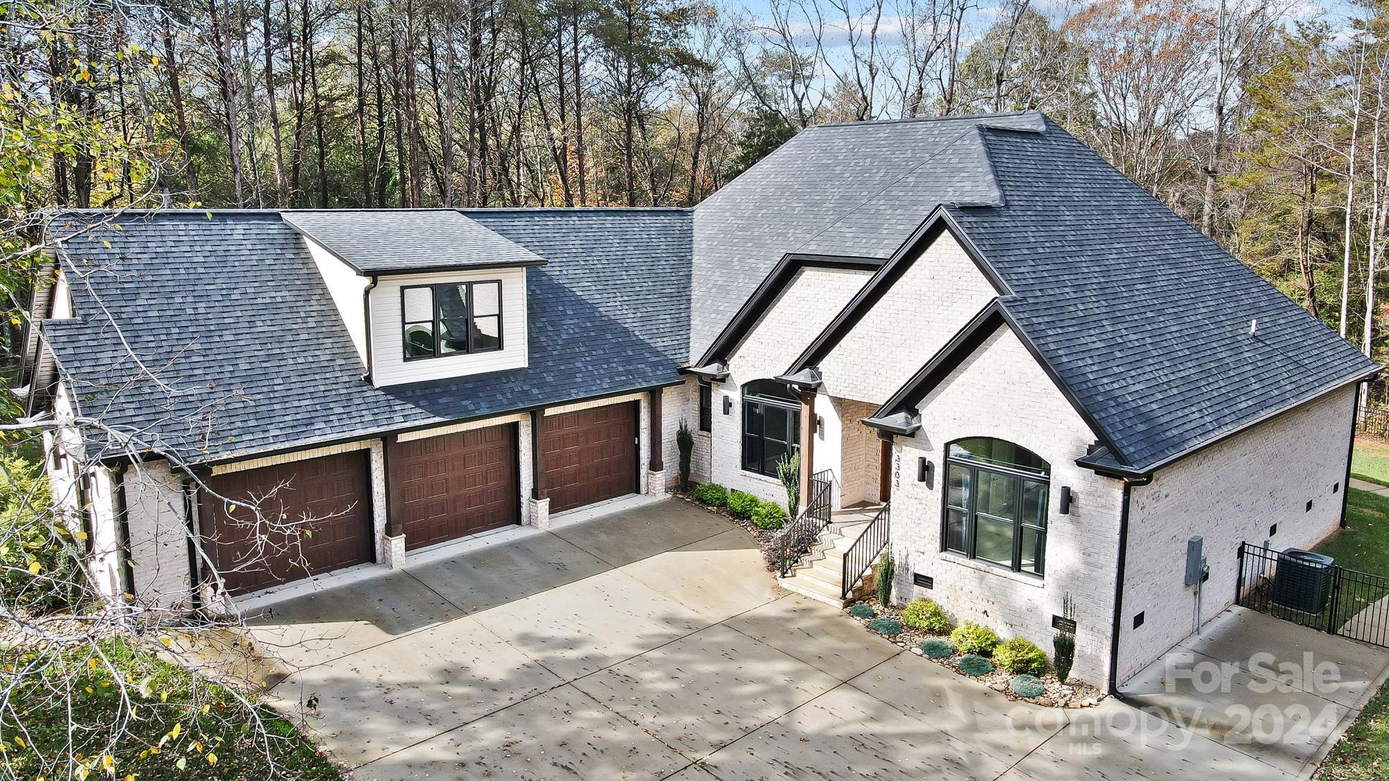 a view of a house with a yard and sitting area