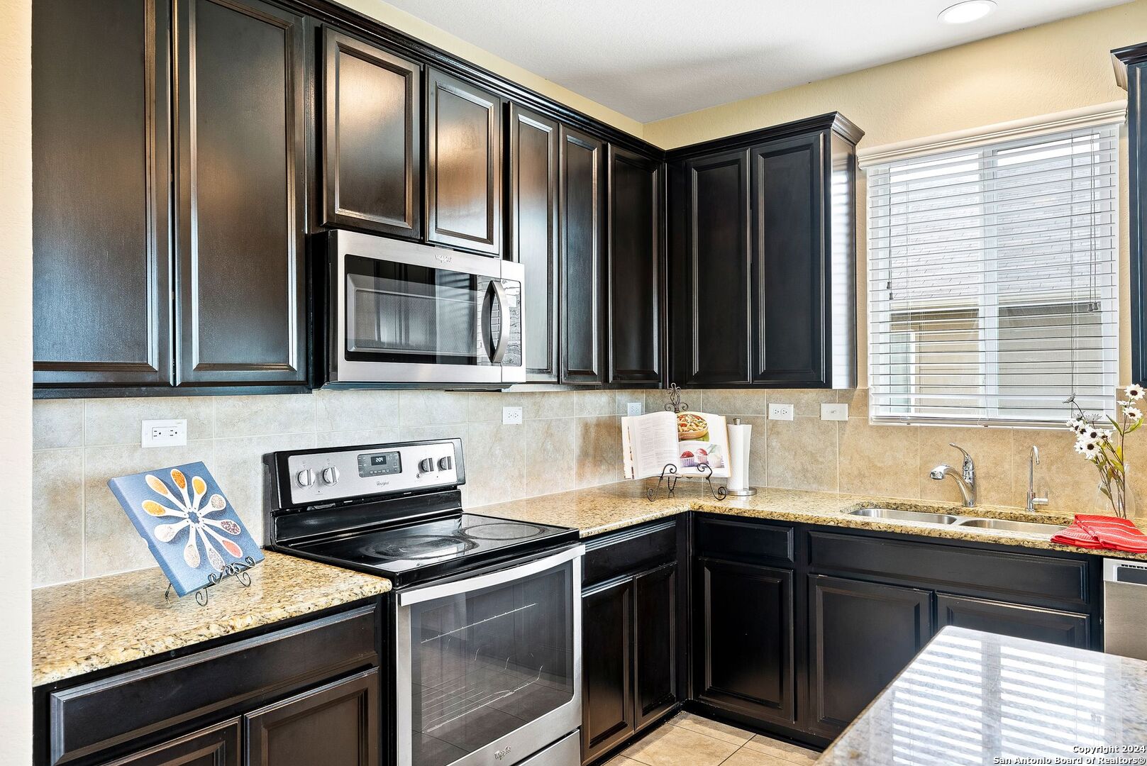 a kitchen with granite countertop stainless steel appliances and sink
