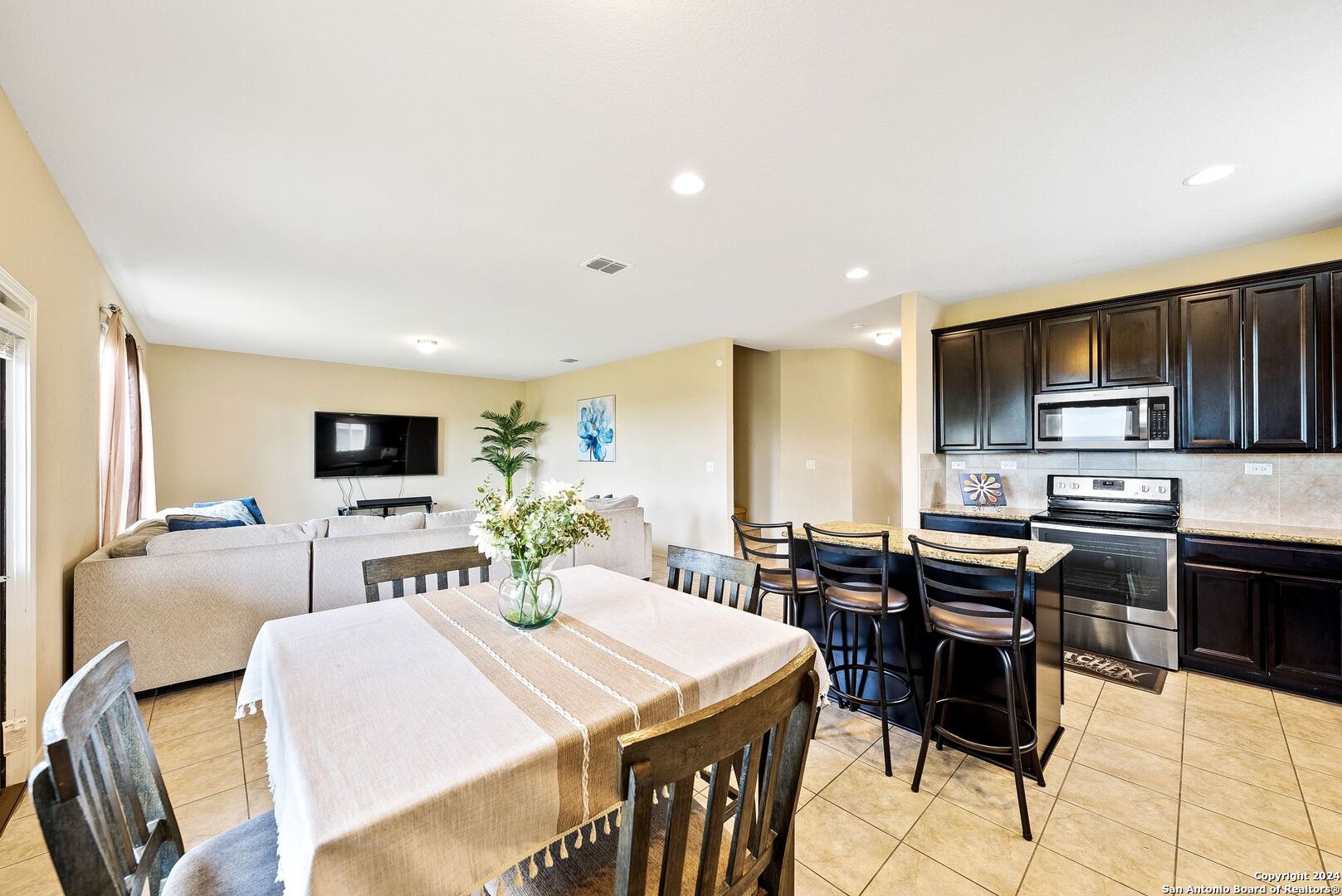 a large kitchen with a table and chairs in it