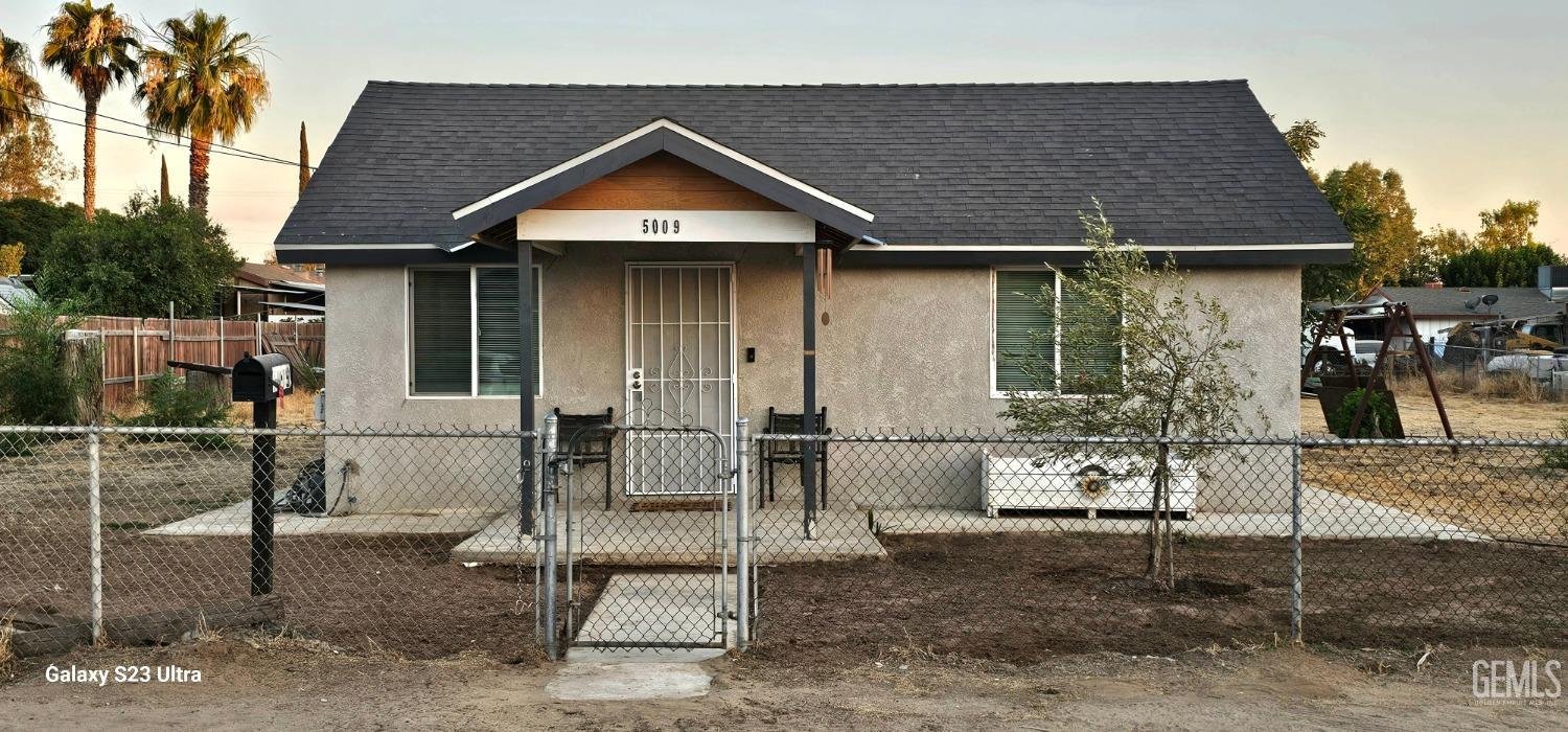 a front view of a house with table and chairs