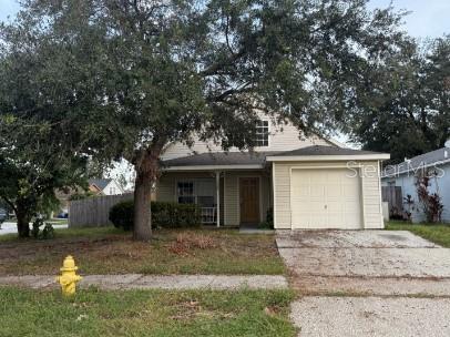 front view of a house with a tree