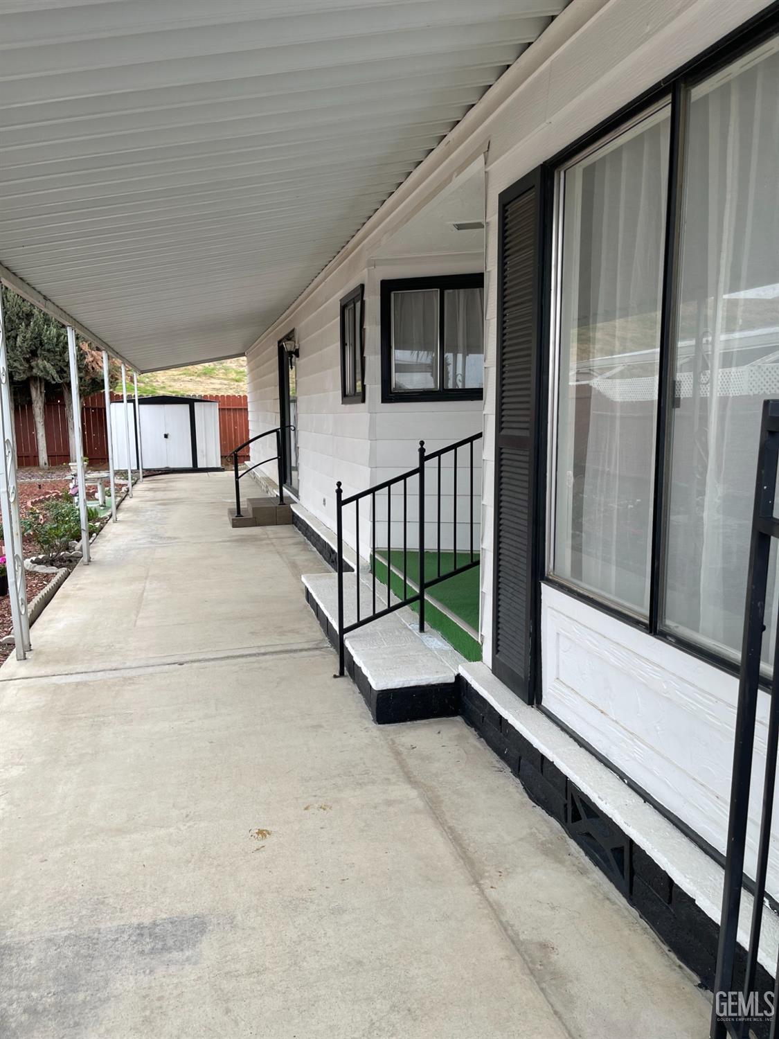 a view of a porch with furniture and floor to ceiling window