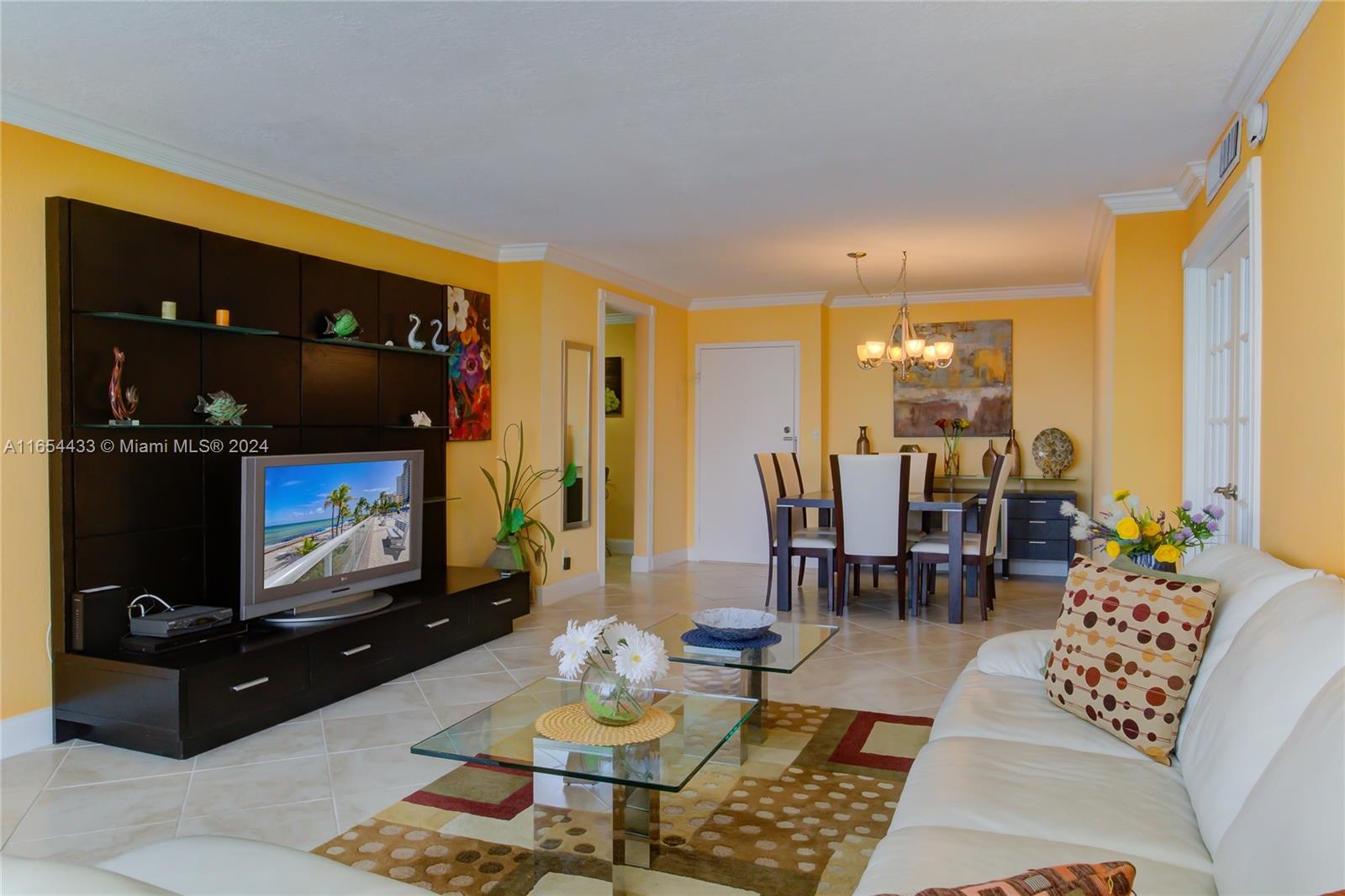 a living room with furniture a rug and a flat screen tv