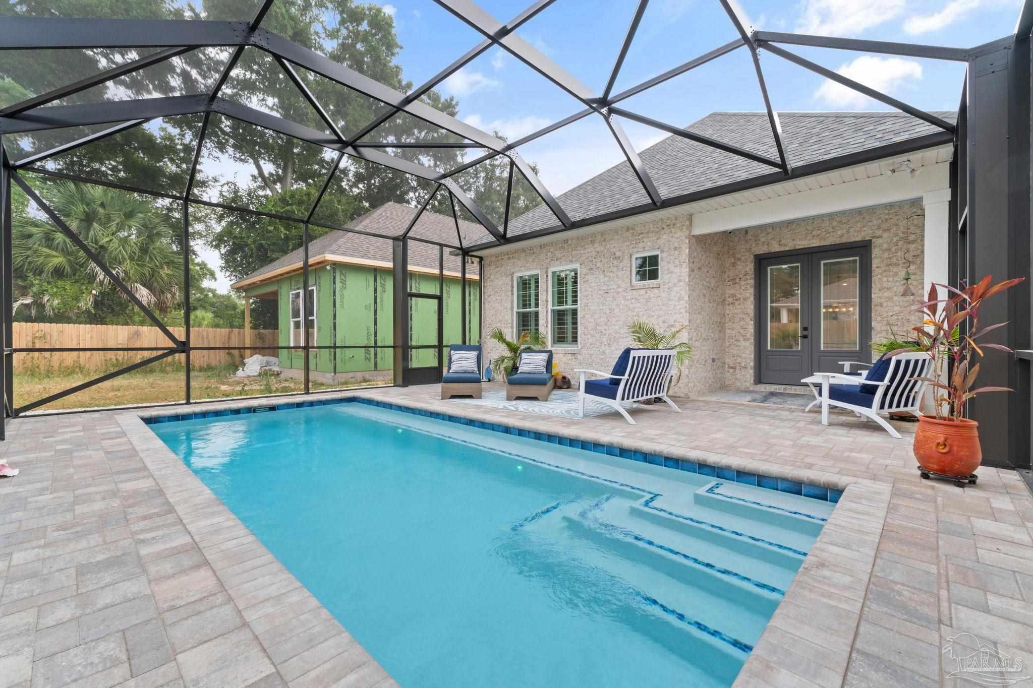 a view of swimming pool with outdoor seating