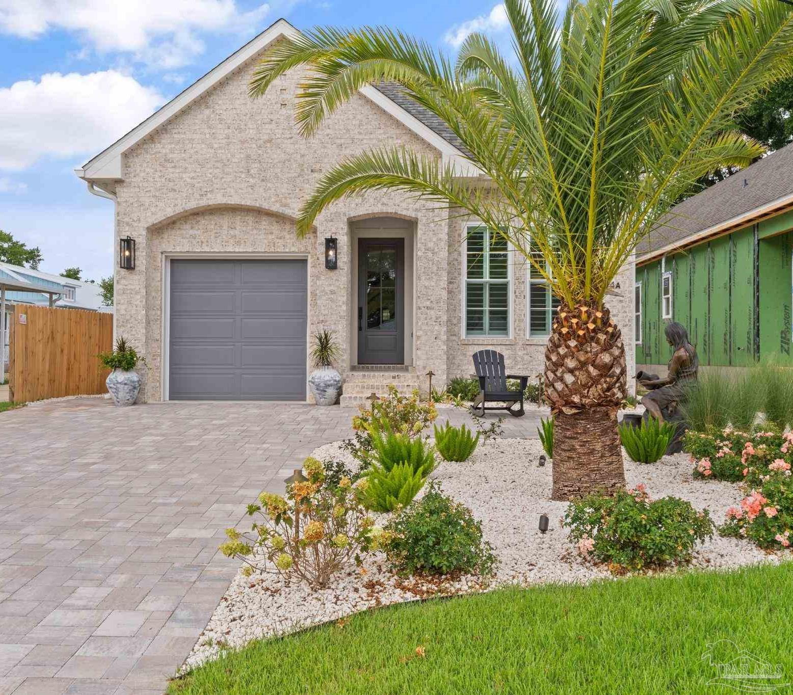 a front view of a house with garden