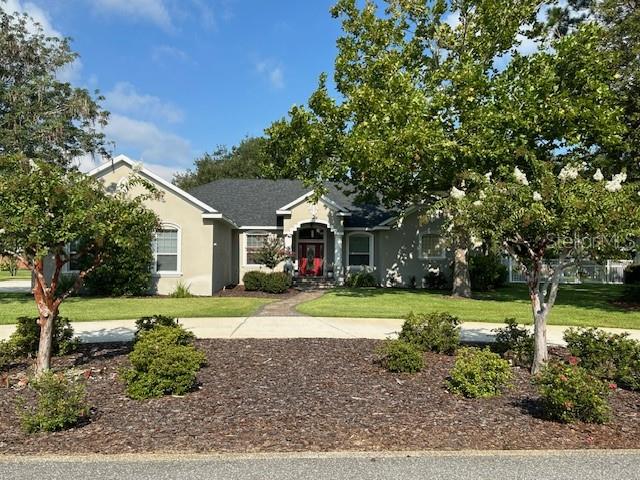 a front view of a house with a yard and pathway