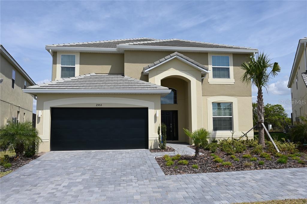 a front view of a house with a yard and garage