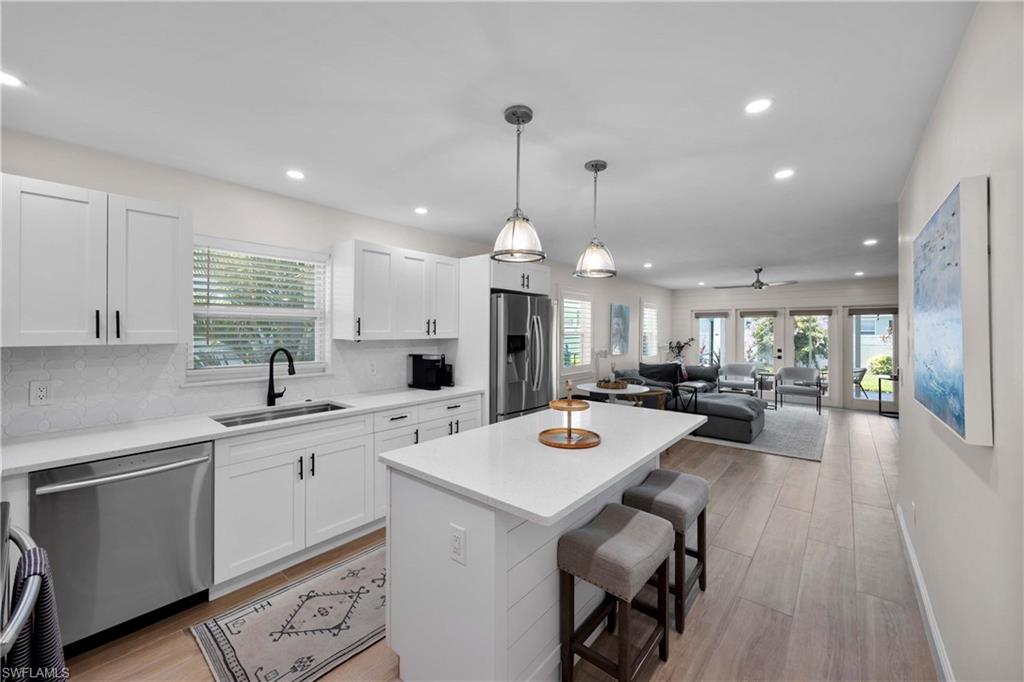 a large kitchen with a table and chairs