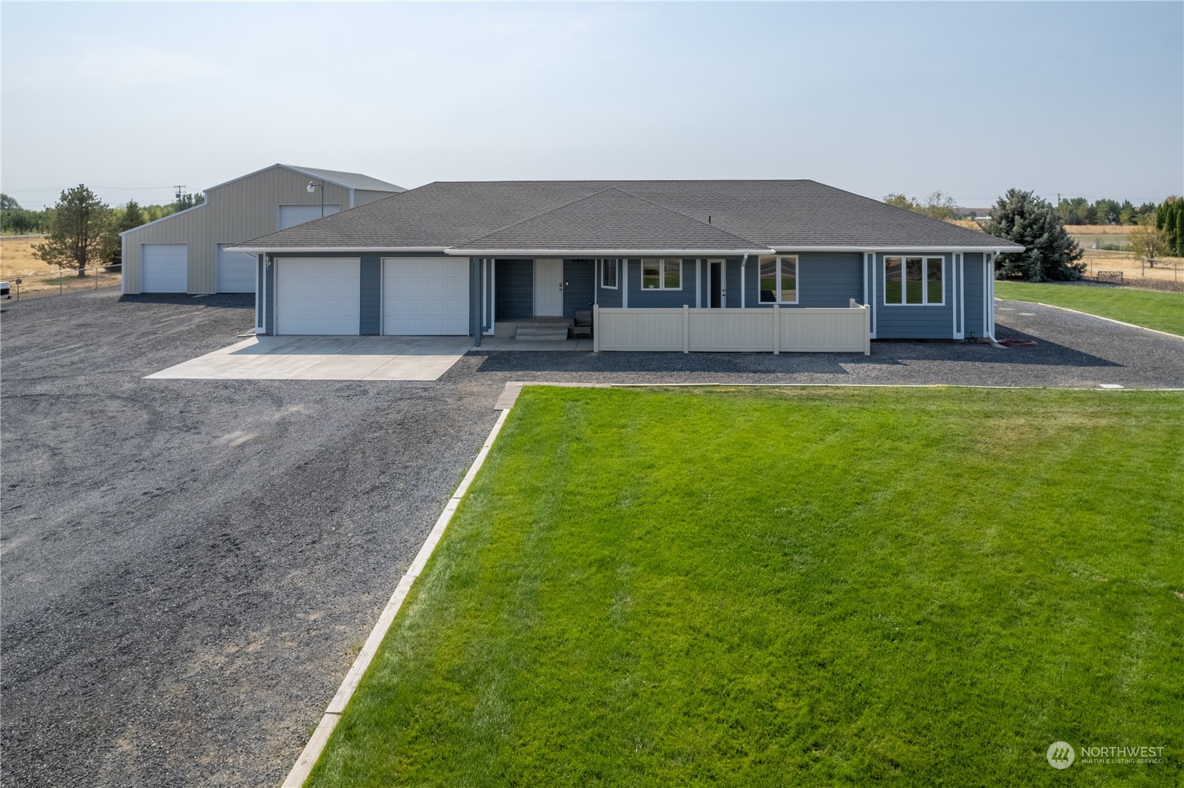 a front view of a house with yard and green space