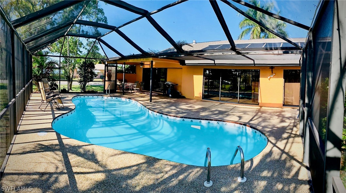 a view of a patio with table and chairs under an umbrella