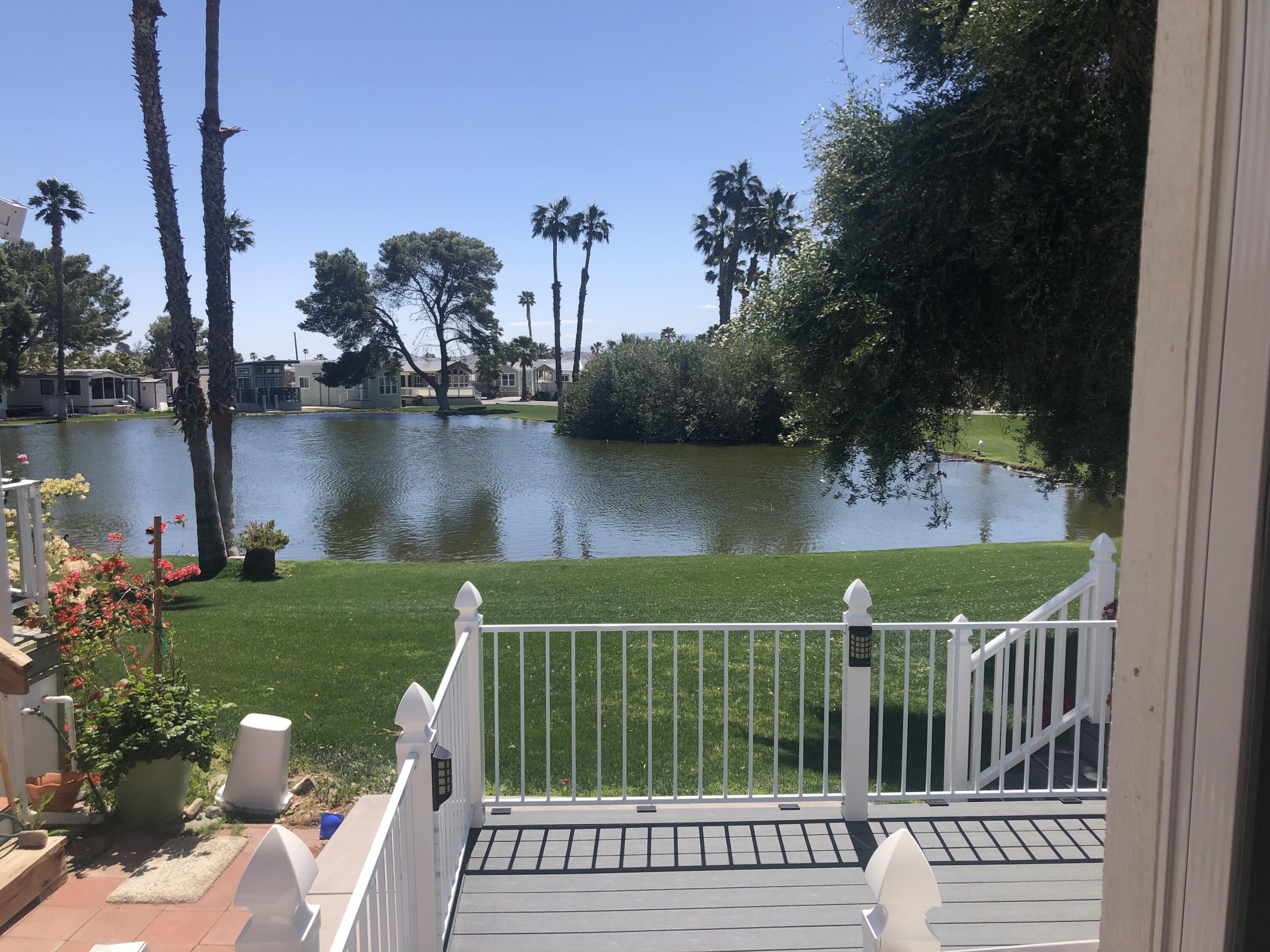 a view of a wooden deck and lake view