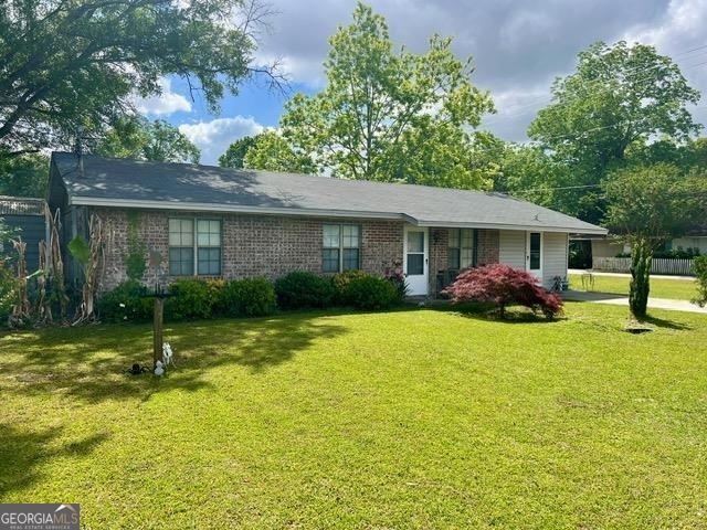 a view of a house with a backyard and a tree